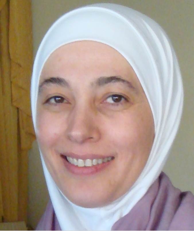 A person wearing a white head scarf

Description automatically generated